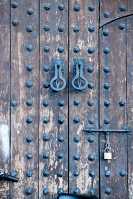 ornate-wooden-door-with-metal-divets