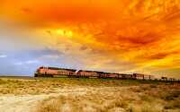 sunset and passing freight train in arizona